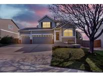 Charming two-story home featuring a three car garage and manicured front lawn at 11575 Wilson Cir, Parker, CO 80134