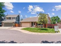 Charming single-Gathering home featuring a well-manicured lawn and two-car garage at 9015 W Tanforan Dr, Littleton, CO 80123