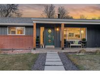 Modern front porch with green door and stone walkway at 5965 W Quarles Dr, Littleton, CO 80128