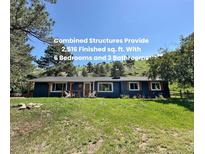 Charming single-story home with blue siding, inviting front porch and manicured lawn at 5384 Olde Stage Rd, Boulder, CO 80302