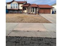 Charming two-story home with a well-maintained lawn and attached two-car garage at 21041 E Ida Ave, Centennial, CO 80015