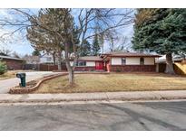 Charming brick accented home featuring a manicured front yard and a vibrant red front door at 12378 E Cedar Cir, Aurora, CO 80012