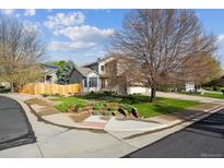 Charming two-story home with a well-maintained front yard, mature trees, and beautiful landscaping at 12705 Home Farm Dr, Westminster, CO 80234