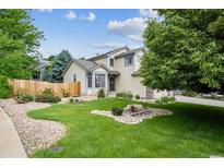 Attractive home featuring a lush green lawn, mature trees, and a charming, well-maintained facade at 12705 Home Farm Dr, Westminster, CO 80234