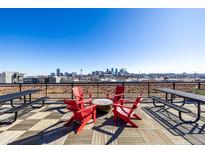 Enjoy city views from this rooftop deck with outdoor seating and picnic tables at 2650 Front View # 205, Denver, CO 80211