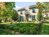 Two-story house with landscaped lawn, charming facade, and teal shutters at 285 Elm St, Denver, CO 80220