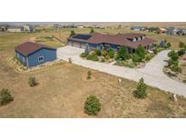 House with a large yard, detached garage and solar panels at 3967 Eastout Ave, Parker, CO 80138
