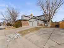 Two-story townhome with attached two-car garage and fenced backyard at 12524 Forest Dr, Thornton, CO 80241