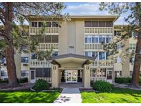 Inviting condo building entrance with manicured lawn and an attractive covered entryway at 725 S Alton Way # 7D, Denver, CO 80247