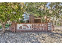 Community sign for Ashley Court with brick base and visible unit numbers at 1300 S Monaco Pkwy # 12, Denver, CO 80224