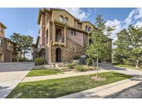 Stunning multi-story townhome features a stone facade, balcony and professional landscaping at 3491 Cascina Pl # D, Highlands Ranch, CO 80126