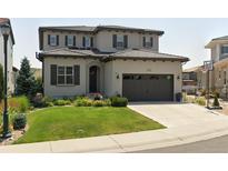 Charming two-story home featuring a well-manicured lawn and a spacious two-car garage at 9724 Cantabria Pt, Lone Tree, CO 80124