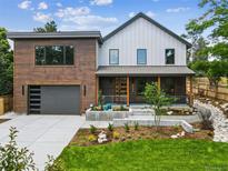 Beautiful two-story home featuring a modern design, landscaped front yard and attached garage at 1321 W Caley Ave, Littleton, CO 80120