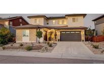 Beautiful two-story home featuring a two-car garage and manicured front yard at 14077 Yellow Tip Drive, Parker, CO 80134
