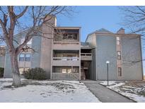 Exterior view of a two story building with snow on the ground at 14190 E Temple Dr # O-04, Aurora, CO 80015