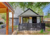 Charming home with a front porch, dark wood accents, and a well-maintained yard at 3429 Avenue D, Kittredge, CO 80457