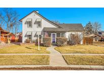 Charming two-story home with landscaped yard and walkway leading to the front door at 248 S 5Th Ave, Brighton, CO 80601