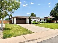 Charming ranch-style home with a well-manicured lawn, a long driveway, and a two car garage in a suburban setting at 4192 S Vrain St, Denver, CO 80236