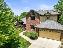 Charming two-story home with a brick exterior, attached garage, and well-manicured lawn at 11072 Zephyr St, Broomfield, CO 80021