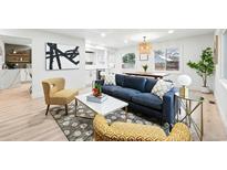 Bright living room featuring modern decor, stylish furnishings, and an open layout at 3067 Robin Way, Denver, CO 80222