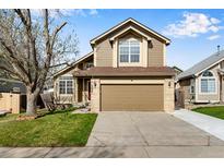 Charming two-story home with a well-manicured lawn and a two-car garage at 12535 Forest View St, Broomfield, CO 80020