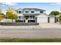 Charming two-story home features a three-car garage, front porch, and beautiful landscaping at 1311 Fletcher Dr, Erie, CO 80516