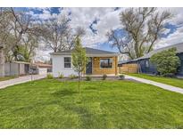 Charming home with a well-manicured front yard, new siding, and walkway leading to the front door at 4874 S Lincoln St, Englewood, CO 80113