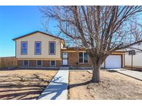 Charming two-story home with a brick and siding exterior and a well-maintained front yard at 1104 S Biscay St, Aurora, CO 80017