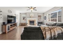 Cozy living room with a fireplace and hardwood floors at 21028 E Saratoga Ave, Aurora, CO 80015