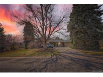 Charming home with mature trees, long driveway, and lush landscaping in a desirable neighborhood at 6671 S Hill Way, Littleton, CO 80120