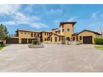 Stunning custom Mediterranean home featuring a grand entrance, fountain, and multiple garage spaces at 8417 High Ridge Ct, Castle Pines, CO 80108
