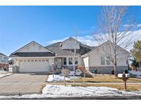 Two-story house with light-colored siding, stone accents, and a three-car garage at 7879 S Zante Ct, Aurora, CO 80016