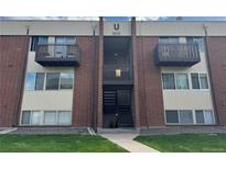 Brick apartment building featuring two balconies and an open staircase entrance at 3613 S Sheridan Blvd # 16, Denver, CO 80235