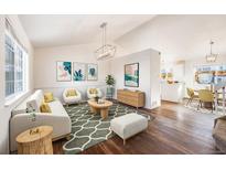 Bright living room with modern decor, stylish rug, and ample natural light at 11840 E 117Th Ave, Commerce City, CO 80640