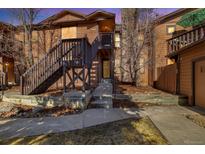 Charming two-story condo with private entrance and wooden stairs leading to the front door at 9587 W 89Th Cir, Broomfield, CO 80021