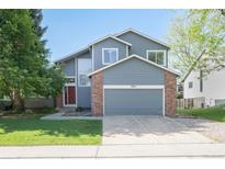 Inviting two-story home with a well-maintained front yard, brick accents and an attached two-car garage at 2935 Bow Line Pl, Longmont, CO 80503