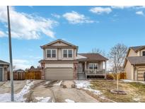 Charming two-story home featuring a covered front porch, attached two-car garage, and well-maintained landscaping at 5819 W 82Nd Cir, Arvada, CO 80003