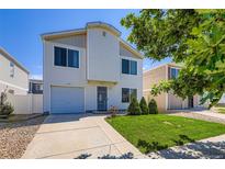 Two-story home featuring a well-maintained lawn and a one-car garage at 4520 Andes St, Denver, CO 80249