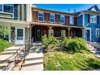 Charming townhome with a covered front porch and well-maintained landscaping at 8231 S Fillmore Way, Centennial, CO 80122