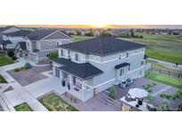 Stunning two-story home showcasing professional landscaping and a golf course view at 16701 Buffalo Run Dr, Commerce City, CO 80022