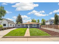 Charming home with a lush lawn, sidewalk and manicured landscape at 309 W Oak St, Lafayette, CO 80026