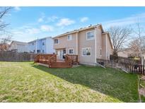 A spacious backyard with a large wooden deck perfect for entertaining and enjoying the outdoors at 12134 Glencoe St, Thornton, CO 80241