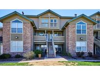 Inviting condo featuring stone accents, private balconies, and well-maintained landscaping at 2846 W Centennial Dr # E, Littleton, CO 80123