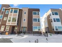 Modern townhouse with a mix of brick and siding, and a convenient front ramp for accessibility at 14245 Currant St, Broomfield, CO 80020