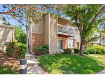 Two-story exterior showcasing a well-maintained lawn, mature trees, and a charming balcony at 4656 S Dillon Ct # D, Aurora, CO 80015