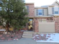 Inviting brick townhome with a lovely front yard and attached garage at 573 Alton Way # B, Denver, CO 80230