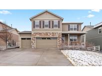 Charming two-story home with a three car garage and stone accents, nestled in a suburban neighborhood at 2065 Shadow Rider Cir, Castle Rock, CO 80104