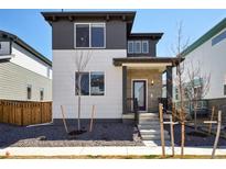 Charming two-story home featuring a modern design with a purple front door and well-maintained landscaping at 21142 E 63Rd Dr, Aurora, CO 80019