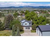 Two story home featuring a two-car garage, a beautiful stone front, and views of the Rocky Mountains at 2610 W County Road 4, Berthoud, CO 80513