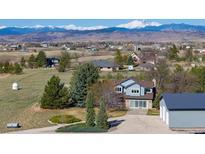 Charming home with mountain views, boasting a large yard and a barn-style detached garage at 2610 W County Road 4, Berthoud, CO 80513